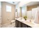 Bathroom featuring dual sinks, tiled floors, and natural light from window at 37252 N Big Bend Rd, San Tan Valley, AZ 85140