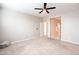 Neutral bedroom with carpet and ceiling fan showing open door to bathroom at 37252 N Big Bend Rd, San Tan Valley, AZ 85140