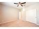 Neutral bedroom with carpet, ceiling fan and open closet with sliding doors at 37252 N Big Bend Rd, San Tan Valley, AZ 85140