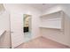 Walk-in closet with open door to bathroom, showing carpet flooring and shelving at 37252 N Big Bend Rd, San Tan Valley, AZ 85140