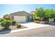 Charming single-story home with a two-car garage, desert landscaping, and mature trees at 37252 N Big Bend Rd, San Tan Valley, AZ 85140