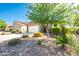 Beautiful front exterior with two car garage, desert landscaping, and mature trees at 37252 N Big Bend Rd, San Tan Valley, AZ 85140