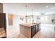 Kitchen island with granite countertops, stainless steel faucet and undermount sink, and open floor plan at 37252 N Big Bend Rd, San Tan Valley, AZ 85140