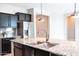 A closer look at the kitchen island, featuring a stainless steel faucet and granite countertops at 37252 N Big Bend Rd, San Tan Valley, AZ 85140