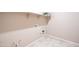 Tile laundry room with modern hookups, open shelving, and neutral paint at 37252 N Big Bend Rd, San Tan Valley, AZ 85140