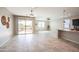 Open living area with sliding glass doors, neutral paint, tile floor and easy access to the kitchen at 37252 N Big Bend Rd, San Tan Valley, AZ 85140