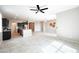 Spacious living room featuring tile floors, a ceiling fan, and an open view to the kitchen area at 37252 N Big Bend Rd, San Tan Valley, AZ 85140