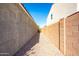 View of side yard of home featuring a gravel walkway, block wall, and stucco exterior at 37252 N Big Bend Rd, San Tan Valley, AZ 85140
