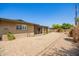 Back exterior featuring gravel yard and covered patio at 3825 W Royal Palm Rd, Phoenix, AZ 85051
