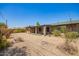 Rear exterior with gravel, block fence, and covered patio at 3825 W Royal Palm Rd, Phoenix, AZ 85051