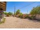 Gravel backyard featuring a block fence and vegetation at 3825 W Royal Palm Rd, Phoenix, AZ 85051