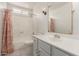 Nautical-themed bathroom features a single sink vanity and shower-tub combination with decorative curtain at 3825 W Royal Palm Rd, Phoenix, AZ 85051