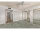 This carpeted bedroom has a mirrored closet and a ceiling fan at 3825 W Royal Palm Rd, Phoenix, AZ 85051