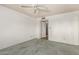 A clean carpeted bedroom features a ceiling fan and an entry doorway at 3825 W Royal Palm Rd, Phoenix, AZ 85051