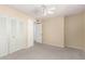 A clean carpeted bedroom has a ceiling fan and a closet with doors at 3825 W Royal Palm Rd, Phoenix, AZ 85051