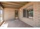 Charming covered patio with brick columns, a cozy welcome mat, and view into the dining room at 3825 W Royal Palm Rd, Phoenix, AZ 85051