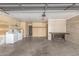 Spacious garage featuring laundry area, workbench, shelving, and ample room for vehicles and storage at 3825 W Royal Palm Rd, Phoenix, AZ 85051