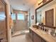 This modern bathroom features a seamless glass shower, granite counter, and stylish fixtures at 4008 La Ultima Piedra --, Carefree, AZ 85377