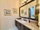 This well-lit bathroom features a granite counter, artwork, and contemporary fixtures at 4008 La Ultima Piedra --, Carefree, AZ 85377