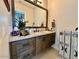 This modern bathroom features stone countertops and wooden cabinets at 4008 La Ultima Piedra --, Carefree, AZ 85377
