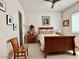 This spacious bedroom features a carved wood bed frame, antique end tables, and light tile floor at 4008 La Ultima Piedra --, Carefree, AZ 85377