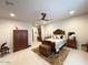 This cozy bedroom features a carved wood bed frame, antique chest, and light tile floor at 4008 La Ultima Piedra --, Carefree, AZ 85377
