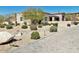 Beautiful desert home featuring decorative stone, lovely landscaping, and a winding brick paver driveway at 4008 La Ultima Piedra --, Carefree, AZ 85377
