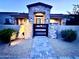 Inviting front entrance with stone accents, a walkway, and modern black gate to a well-lit, single-story home at 4008 La Ultima Piedra --, Carefree, AZ 85377