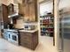 Contemporary kitchen featuring stainless steel appliances, custom cabinetry, and a pantry at 4008 La Ultima Piedra --, Carefree, AZ 85377