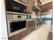 Kitchen featuring stainless steel oven, cooktop, microwave, refrigerator, and custom cabinets at 4008 La Ultima Piedra --, Carefree, AZ 85377