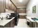 This modern laundry room has generous cabinet space and a front-loading washer and dryer at 4008 La Ultima Piedra --, Carefree, AZ 85377