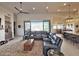 Living room with large windows and ceiling fan, open to kitchen and dining areas at 4008 La Ultima Piedra --, Carefree, AZ 85377