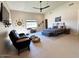 Large main bedroom features ceiling fan, lounge chair, and oversized window with view to backyard at 4008 La Ultima Piedra --, Carefree, AZ 85377