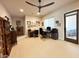 This home office features built-in shelving, tile floors, and natural light from an external door and window at 4008 La Ultima Piedra --, Carefree, AZ 85377