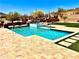Sparkling pool with spa, artificial turf, and desert landscaping at 4008 La Ultima Piedra --, Carefree, AZ 85377