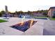 Backyard pool and fire pit with desert landscape at sunset at 4008 La Ultima Piedra --, Carefree, AZ 85377