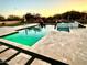 Sparkling pool with travertine deck, lush landscaping, and desert mountain views; perfect for outdoor relaxation at 4008 La Ultima Piedra --, Carefree, AZ 85377
