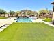 Gorgeous pool area with lush artificial turf, spa, and serene desert landscape at 4008 La Ultima Piedra --, Carefree, AZ 85377