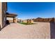 Large backyard with a covered patio, outdoor grill, play area, and privacy fencing at 40213 W James Ln, Maricopa, AZ 85138