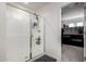 Modern bathroom with a glass-enclosed shower and access to a walk-in closet at 40213 W James Ln, Maricopa, AZ 85138