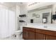 Bathroom featuring a vanity with wood cabinets, and a walk-in shower at 40213 W James Ln, Maricopa, AZ 85138