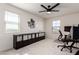 Bright bedroom featuring natural light, modern ceiling fan, and custom organization system at 40213 W James Ln, Maricopa, AZ 85138