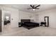 Bright bedroom showcasing plush carpet, neutral walls, a ceiling fan, and natural light at 40213 W James Ln, Maricopa, AZ 85138