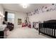 Cozy ' bedroom featuring a floral wall, comfortable seating, and ample storage at 40213 W James Ln, Maricopa, AZ 85138