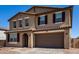 Beautiful two-story home featuring a desert landscape, brick driveway and a two car garage at 40213 W James Ln, Maricopa, AZ 85138