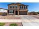 Beautiful two-story home featuring a desert landscape, brick driveway and a two car garage at 40213 W James Ln, Maricopa, AZ 85138