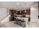 Kitchen featuring a center island with seating, stainless steel appliances and a tiled backsplash at 40213 W James Ln, Maricopa, AZ 85138