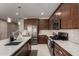 Kitchen featuring a center island, stainless steel appliances and dark wood cabinets at 40213 W James Ln, Maricopa, AZ 85138