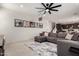 Open concept first floor featuring light wood-look floors and a gray sectional couch at 40213 W James Ln, Maricopa, AZ 85138