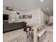 Bright living and dining area with light wood-look floors and an open layout at 40213 W James Ln, Maricopa, AZ 85138